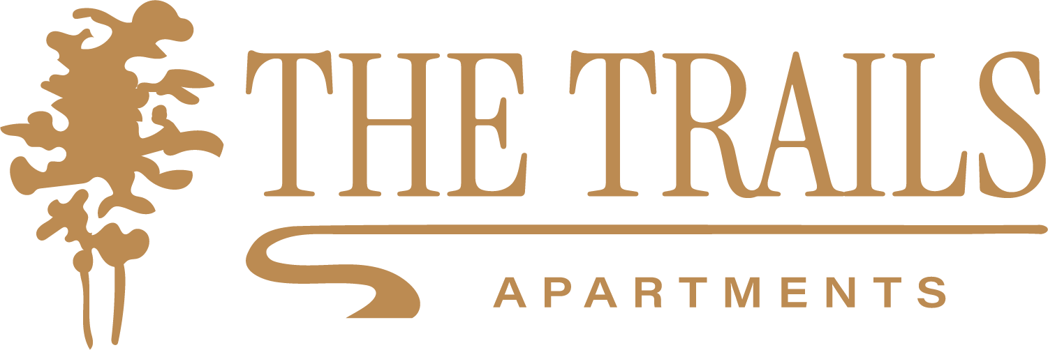 The image is a logo for "The Trails Apartments".